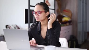 Genç Afrikalı iş kadını video ile iletişim kuruyor. Etnik iş kadını dizüstü bilgisayara bakarak konuşuyor, online konferans ofis sohbeti, sanal eğitim kavramı.