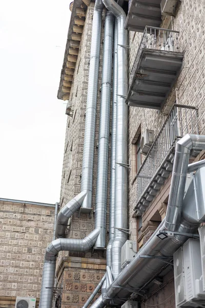 stock image Gray metal fan pipe on buiding wall outside the buidling