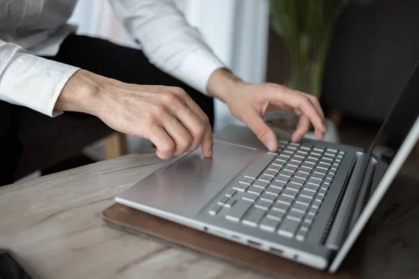 stock image Businessman working on new project with notebook computer, digital tablet on table at office. Business man sitting at desk, hands typing on notebook computer, close up