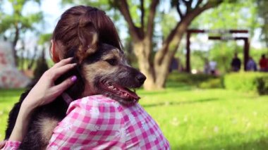 Parkta genç köpeğiyle oynayan güzel bir genç kadın. Yaşam tarzı portresi.