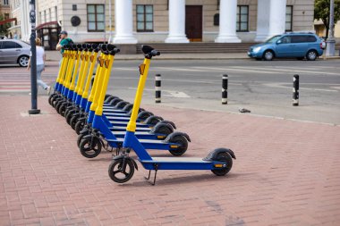 Electric scooters for public share standing outside in european city center public mobile transport