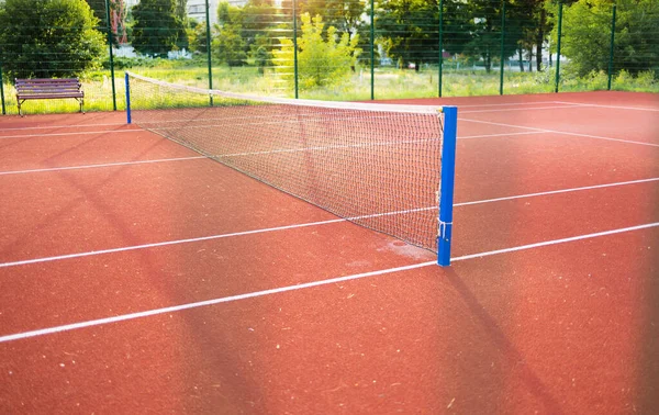 stock image New outdoor red tennis courts with white lines and gray pickleball lines.