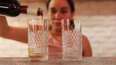 Woman barista making iced black coffee with orange juice in takeaway glass. coffee shop waiter serving coffee to customer on counter at cafe. Small business cafe and restaurant owner concept.