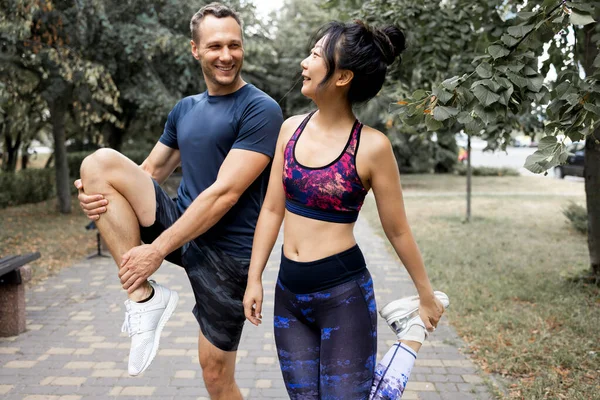 Young couple jogging together in the park. Healthy lifestyle concept.