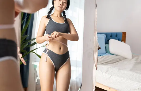美丽而性感的年轻亚洲女人瘦瘦的体形 腰围与腹部相映 镜中倒影纤细的女人 体积小 体重减轻 生活方式简洁 — 图库照片