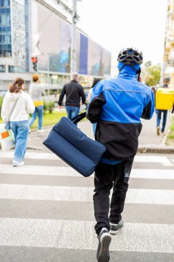 Pizza teslimatı, termal çantalı çocuk şehir caddesinde yiyecek getiriyor. Yemek servisi, sisli bir günde pizza teslimatı..