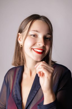 Kocaman sağlıklı beyaz dişleri olan genç bir kadının güzel, geniş gülümsemesi. Pastel renk arkaplanında izole.