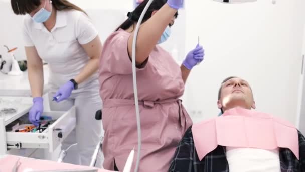 Dokter Gigi Muda Mengenakan Optragate Untuk Pasien Laki Laki Mempersiapkan — Stok Video