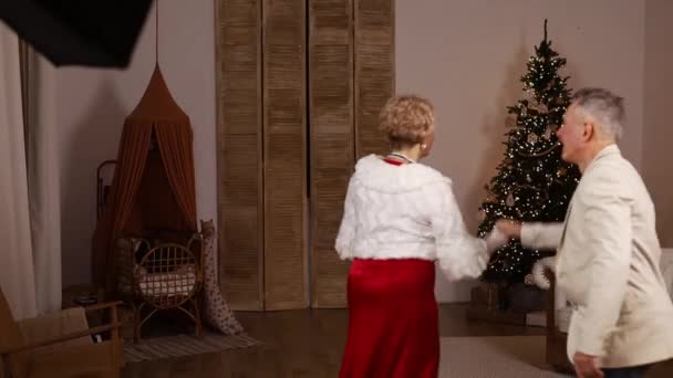 Stylish Mature Couple Dancing Home Front Christmas Tree — Stock Video