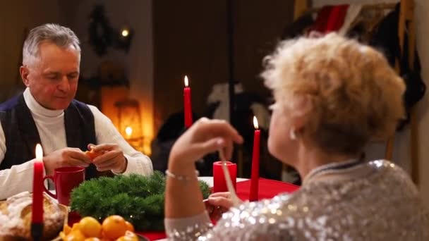 Christmas Dinner Home Tangerine Senior Couple Sitting Table Kitchen Eating — Stock Video