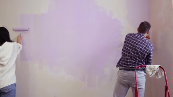 Пара Холдинг Роликовые Кусты Нанести Фиолетовый Цвет Краски Новый Дом — стоковое видео