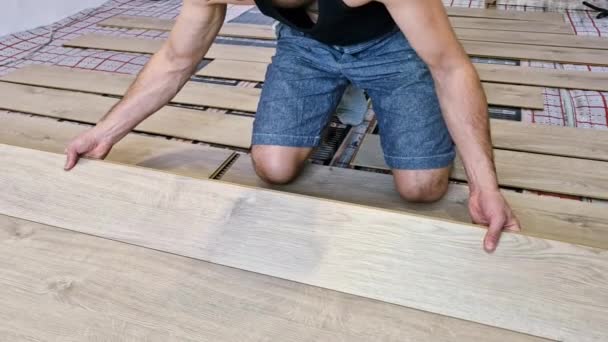 一个工作和使用不同工具的年轻人 关闭安装底层暖气和建造房屋木地板的人 — 图库视频影像