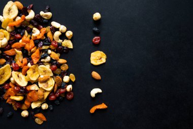 Fındıklı kurutulmuş meyve. Kaju, fındık, fıstık, kurutulmuş kayısı, viburum, kuru üzüm. Sağlıklı atıştırmalıklar. Kopyalama alanı olan üst görünüm.