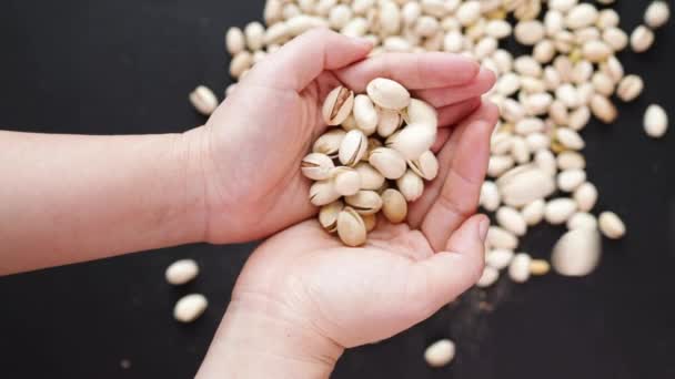 Various Pistachio Nuts Female Hands Black Background — Stock Video