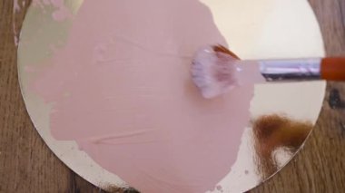 beige smear of tonal foundation cream close up, smudge with a brush, beautiful pastel texture, cosmetic product for make up