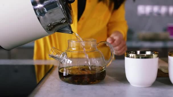 Woman Yellow Shirt Pours Tea Two White Cups Hospitality Concept — Stock Video