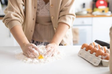 female hands skillfully kneading raw bread dough for homemade bread cooking. Bakery concept. Close-up. Preparation of the dough.
