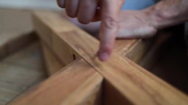 Bir adam ahşap mobilyaları el aletleriyle monte eder, yakın plan..