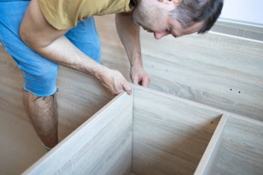 Mobilya montajı. El ele tutuşup oturma odası için yeni bir mobilya monte ediyoruz..