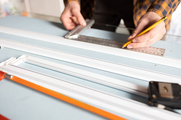 Installing mosquito net on windows in residential area. young man installing mosquito net in room.