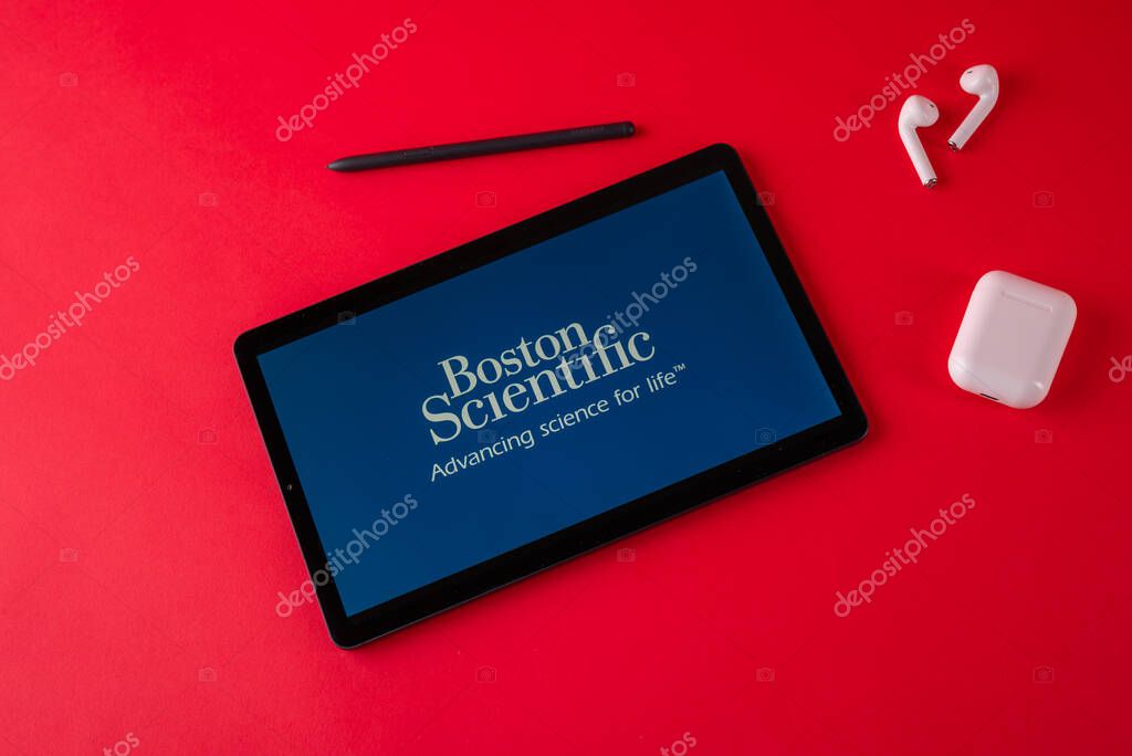Tula, Russia - october 19, 2021: Boston Scientific displayed modern laptop on red background