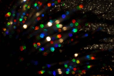 Noel arkaplanı. Bokeh odaklı ışıklar ve yıldızlarla şenlikli soyut arkaplan.