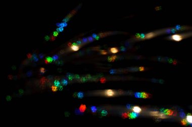 Noel arkaplanı. Bokeh odaklı ışıklar ve yıldızlarla şenlikli soyut arkaplan.