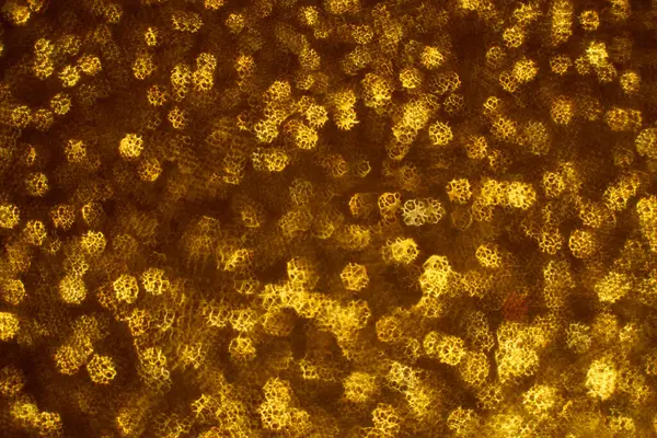 Noel arkaplanı. Bokeh odaklı ışıklar ve yıldızlarla şenlikli soyut arkaplan.