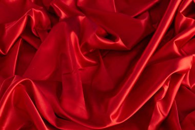 Kırmızı ipek ya da saten lüks kumaş dokusu soyut bir arka plan olarak kullanılabilir. Üst görünüm.