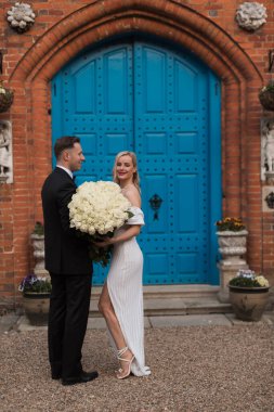 The bride and groom holds a wedding big bouquet of flowers The b