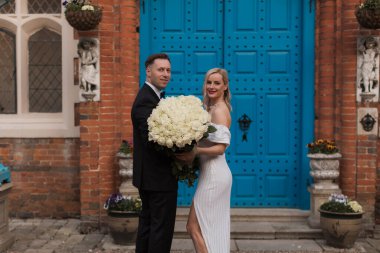 The bride and groom holds a wedding big bouquet of flowers The b