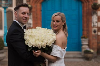 The bride and groom holds a wedding big bouquet of flowers The b