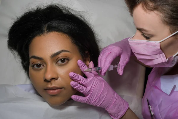 Woman receiving injection in medical practice. High quality photo