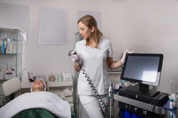 Cosmetologue Est Debout Machine Épilation Laser Souriant Femme Manteau Blanc — Photo