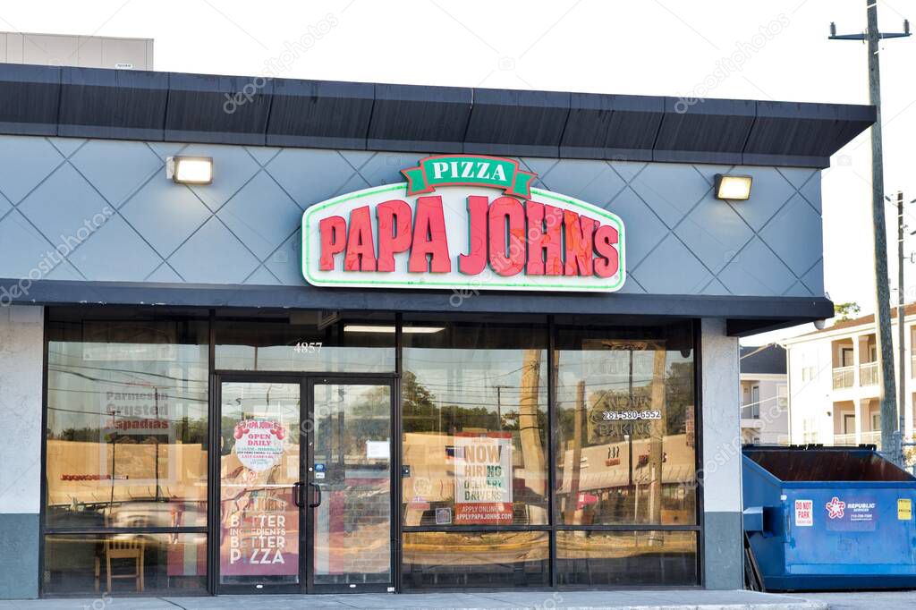 Houston, Texas USA 10-27-2022: Papa John's pizza storefront exterior in Houston, TX. Popular American fast food restaurant chain founded in 1984.