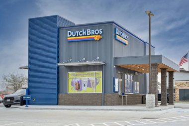 Houston, Texas USA 02-26-2023: Dutch Bros Coffee business exterior and drive-thru in Houston, TX. American coffee and beverage chain store, founded in 1992. clipart