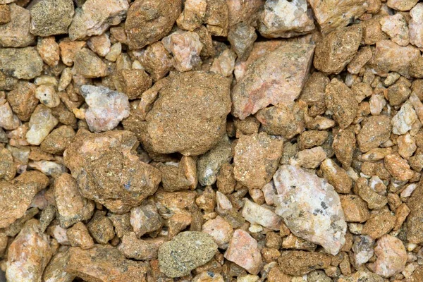 Colorful pea gravel sample river rock style, macro details directly above. Common material for lawn replacement, garden decoration and driveways.