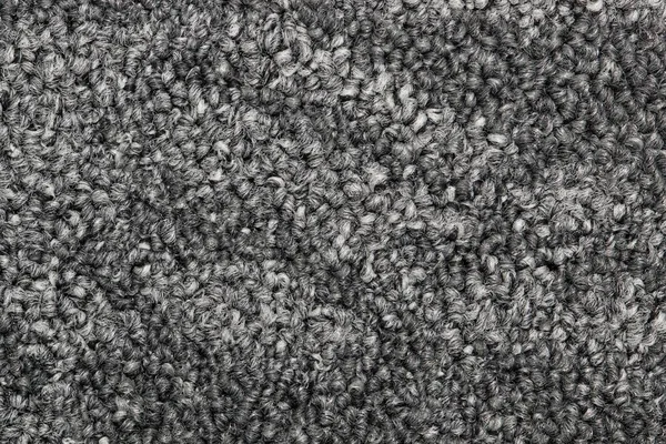 Dark gray color two tone swatch section of carpet sample, closeup directly above full frame image.