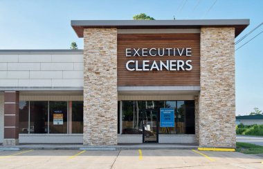 Houston, Texas USA 06-23-2024: Executive cleaners dry cleaning business storefront exterior. clipart