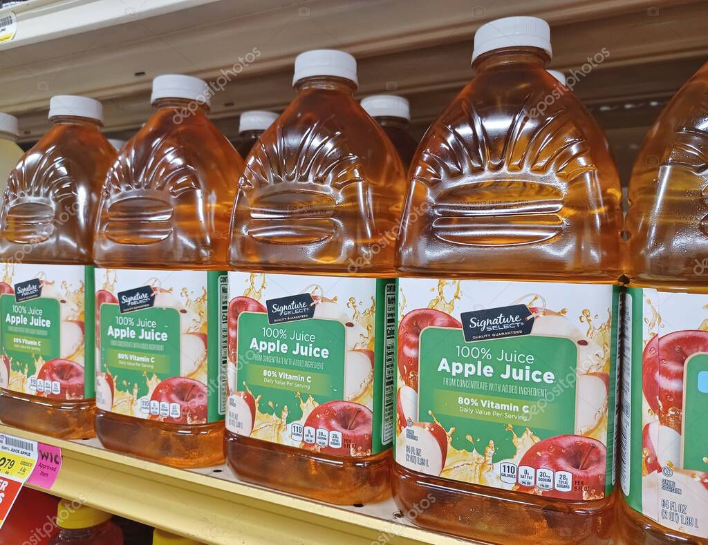 Houston, Texas USA 09-01-2024: Apple juice plastic bottles Signature Select brand name.