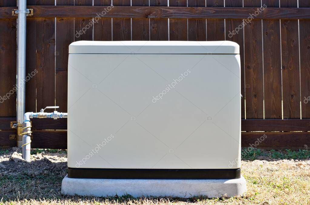 Standby home generator set in residential backyard, emergency backup power supply electricity generation.