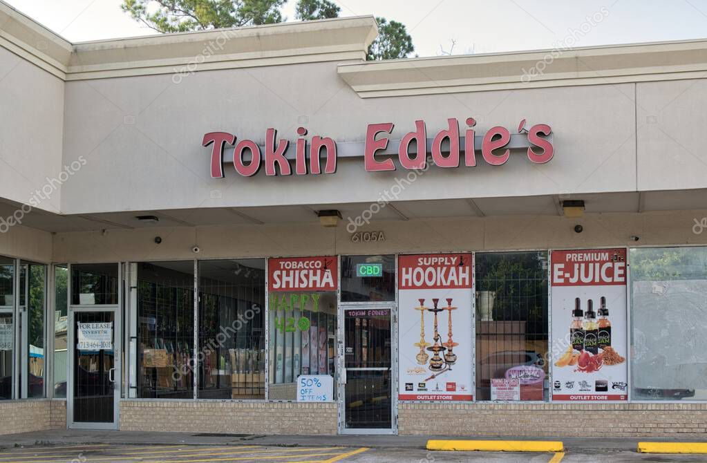 Houston, Texas USA 06-23-2024: Tokin Eddies smoke shop business storefront exterior. Local hookah and smoke shop company.