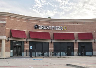 Houston, Texas USA 07-20-2025: Crust Pizza restaurant business storefront exterior local diner.