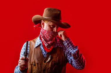 American bandit in mask, western man with hat. Portrait of man wearing cowboy hat, gun, macho. West, guns. Portrait of farmer or cowboy in hat. Portrait of a cowboy. American farmer.