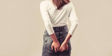 Hemorrhoids. Anus. Ass Pain. Woman suffering from hemorrhoids, anal pain. Woman hand holding her bottom because having Abdominal pain and Hemorrhoids.