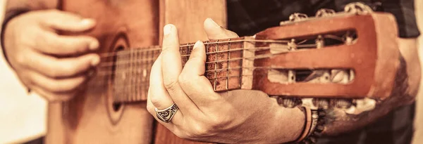 Acoustic guitars playing. Music concept. Music festival. Male musician playing guitar, music instrument. Mans hands playing acoustic guitar, close up.