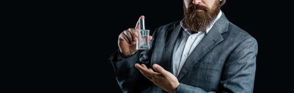 Male holding up bottle of perfume. Man perfume, fragrance. Masculine perfume, bearded man in a suit.