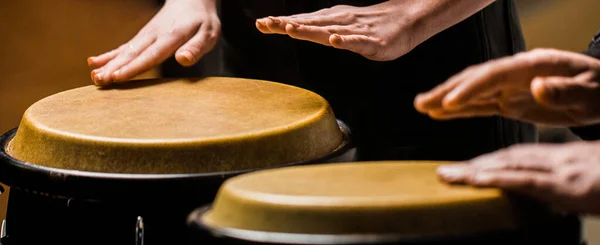 stock image The musician plays the bongo. Close up of musician hand playing bongos drums. Afro Cuba, rum, drummer, fingers, hand, hit.