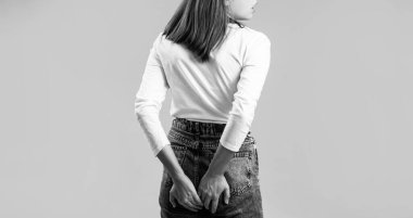 Hemorrhoids. Anus. Ass Pain. Woman hand holding her bottom because having Abdominal pain and Hemorrhoids. Woman suffering from hemorrhoids, anal pain. Black and white.