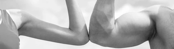 Sporty man and woman. Muscular arm vs weak hand. Vs, fight hard. Competition, strength comparison. Black and white.